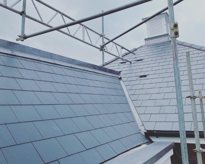 Blue slate roof under construction with scaffolding