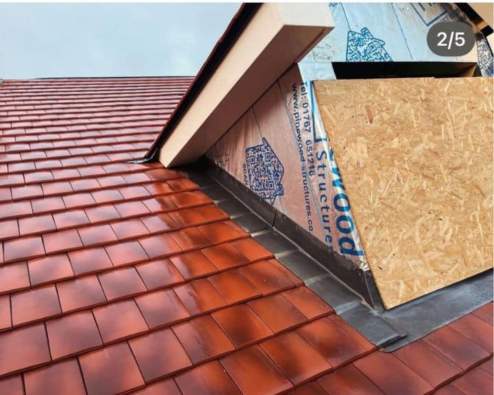 New red tiled roof under construction