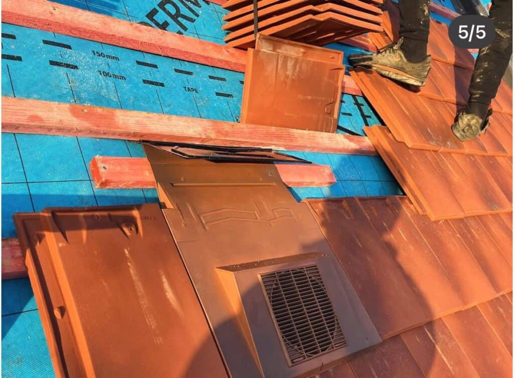 Installing roof tiles with ventilation panel