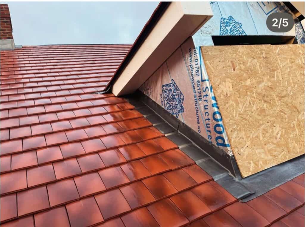 Red tiled roof with construction materials.