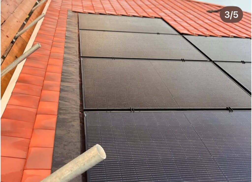 Close-up of solar panels on tiled rooftop.
