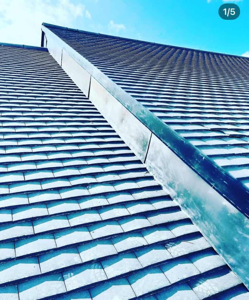 Close-up of tiled roof under blue sky.
