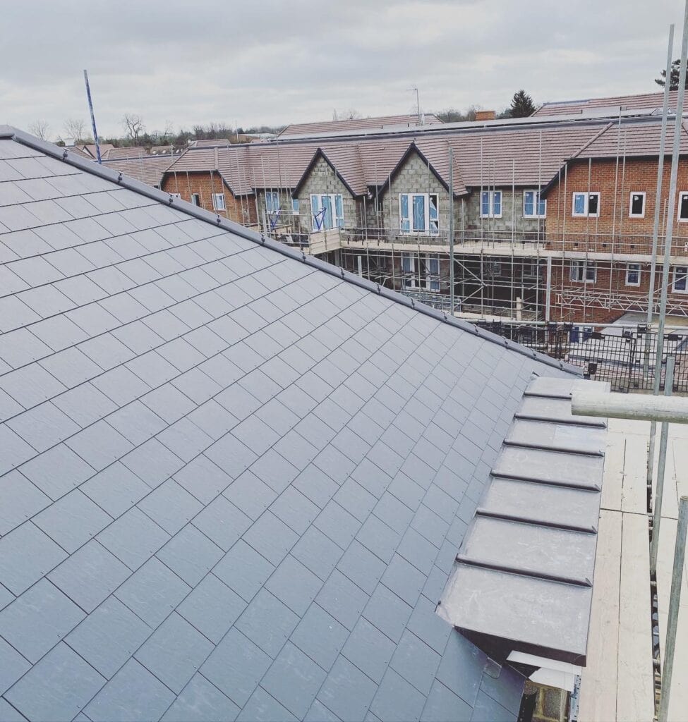 Newly constructed slate roof on building site.
