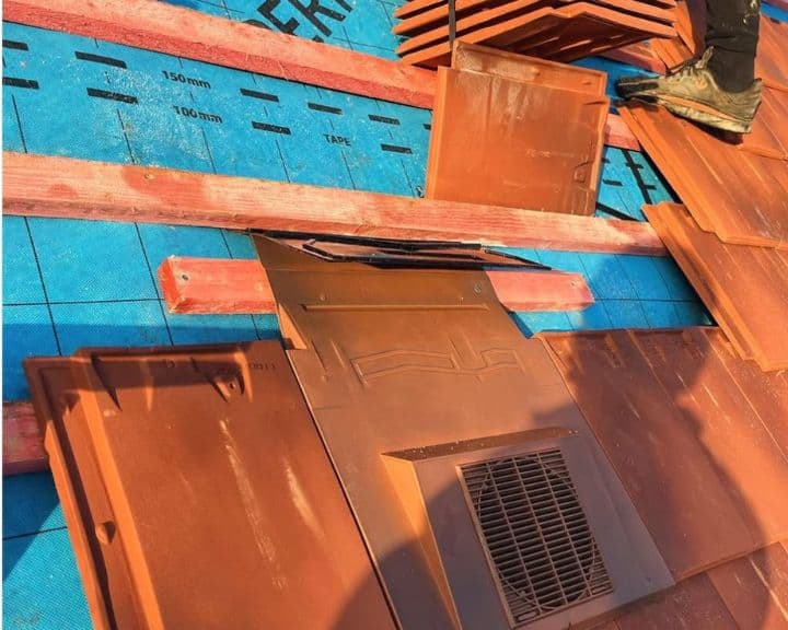 Installation of roof tiles on underlay.