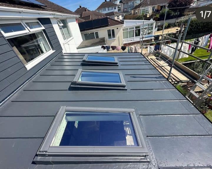 Modern roof with three skylights and scaffolding.
